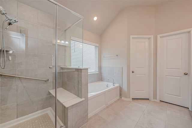 bathroom featuring separate shower and tub, vaulted ceiling, and tile patterned floors