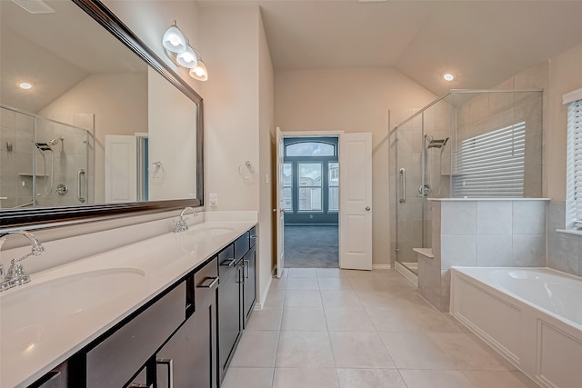 bathroom with vaulted ceiling, tile patterned floors, plus walk in shower, and vanity