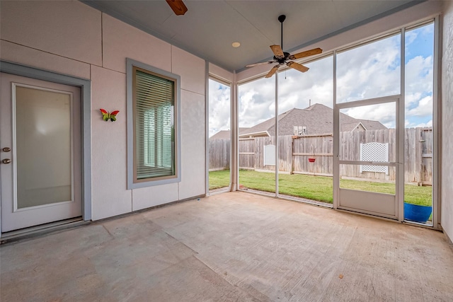 unfurnished sunroom with ceiling fan