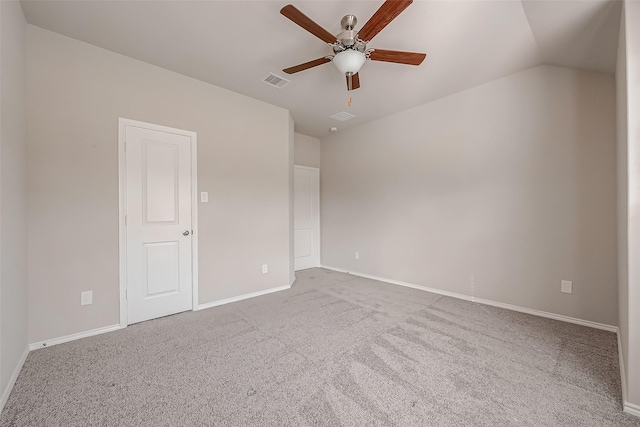 empty room with ceiling fan, lofted ceiling, and carpet floors