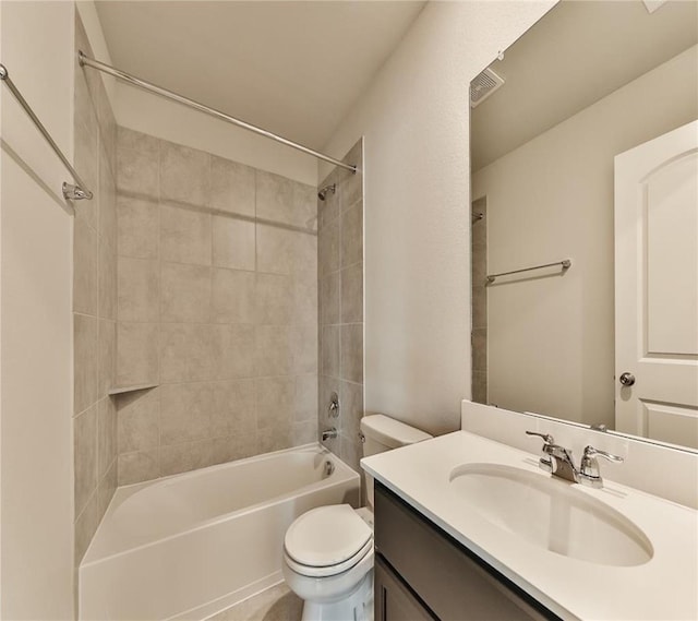 full bathroom featuring toilet, vanity, and tiled shower / bath