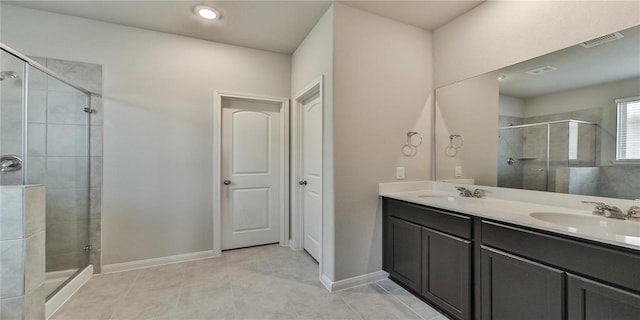 bathroom with walk in shower, vanity, and tile patterned flooring