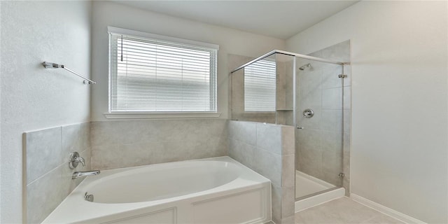 bathroom featuring tile patterned floors and separate shower and tub