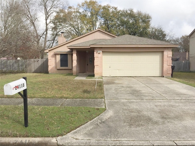 ranch-style house featuring a front yard and a garage