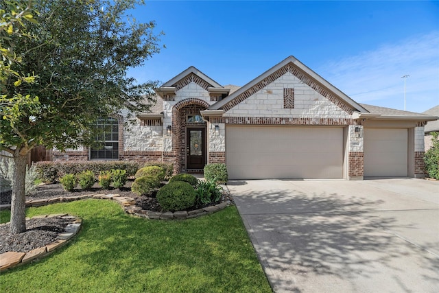 view of front of home with a garage and a front lawn