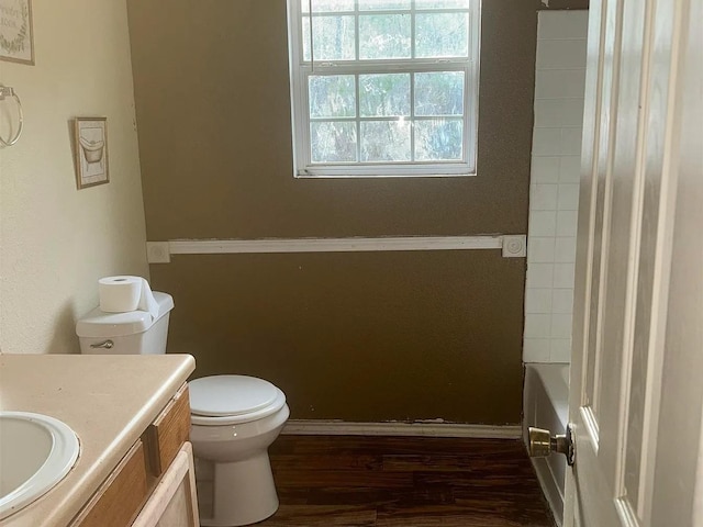 bathroom featuring toilet, hardwood / wood-style floors, and vanity