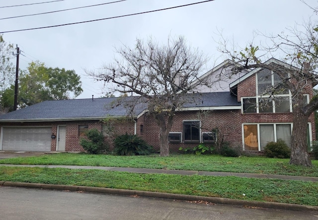 front facade featuring a garage and a front yard