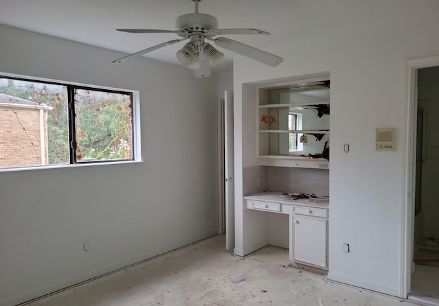 interior space with ceiling fan and backsplash