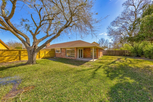 rear view of property with a patio area and a yard