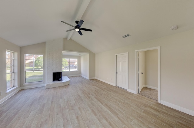 unfurnished living room with ceiling fan, light hardwood / wood-style flooring, and vaulted ceiling with beams