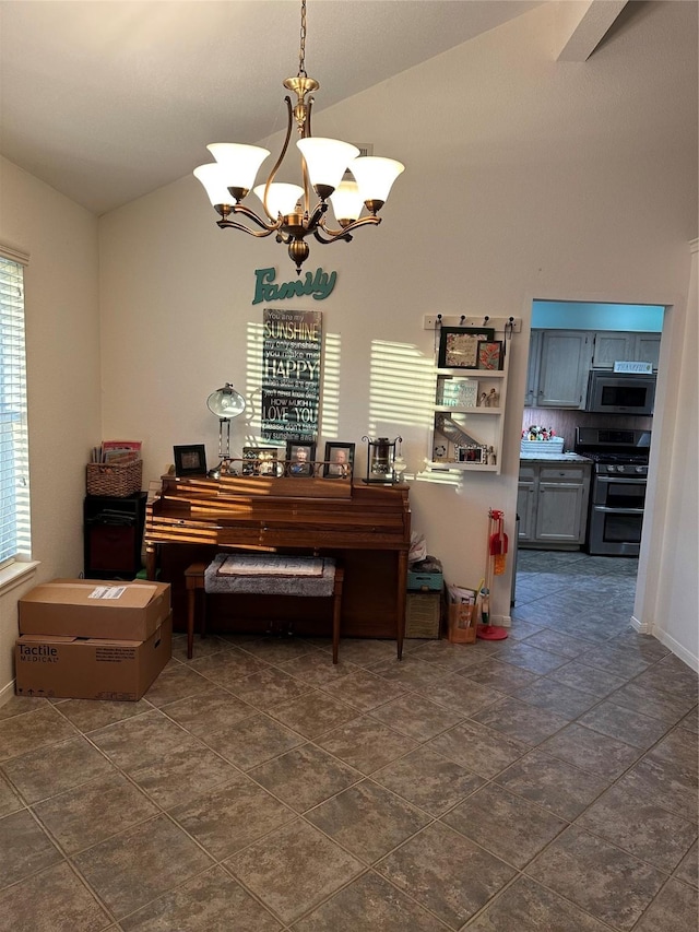 miscellaneous room featuring lofted ceiling, a healthy amount of sunlight, and an inviting chandelier