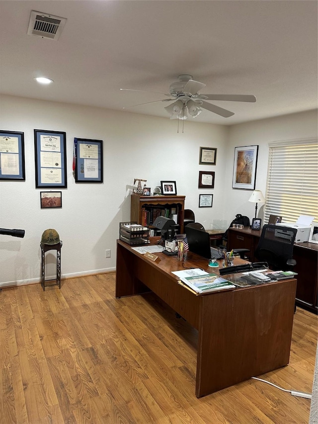 office with ceiling fan and light wood-type flooring