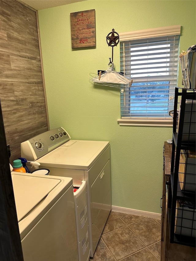 laundry area featuring dark tile patterned flooring and washing machine and clothes dryer