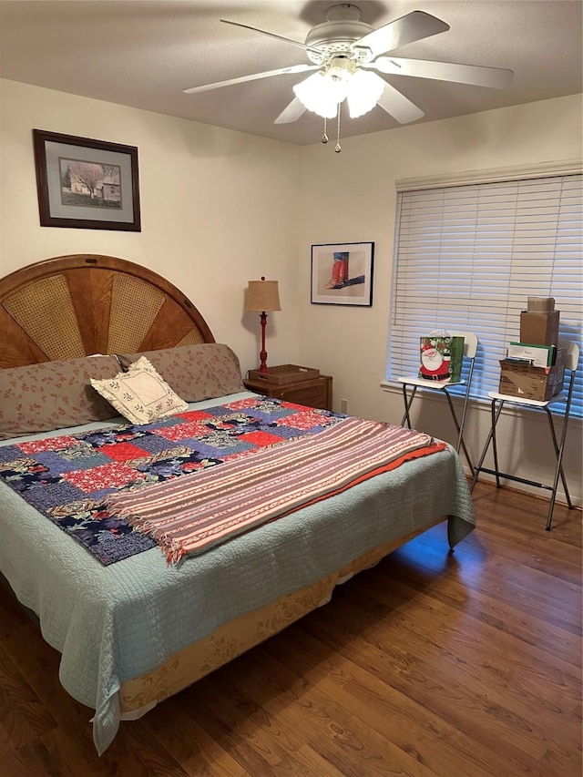 bedroom with ceiling fan and hardwood / wood-style flooring