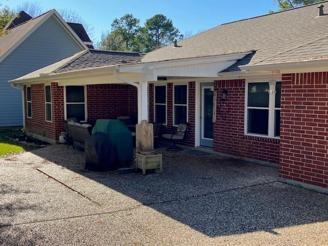 rear view of property featuring a patio area