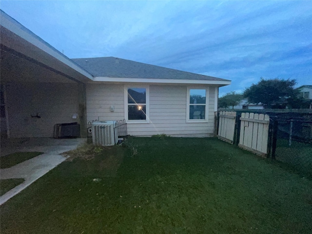 view of home's exterior with a lawn and central air condition unit