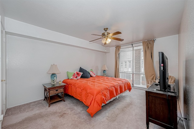 bedroom with light carpet and ceiling fan