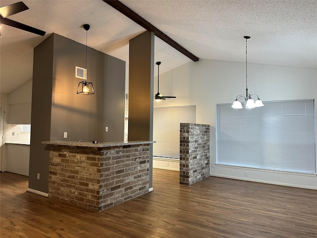 bar featuring a textured ceiling, dark hardwood / wood-style flooring, ceiling fan with notable chandelier, and vaulted ceiling with beams