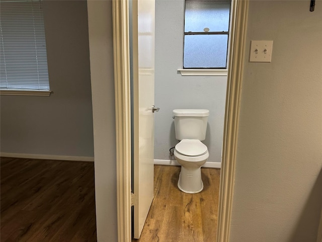 bathroom with toilet and hardwood / wood-style flooring