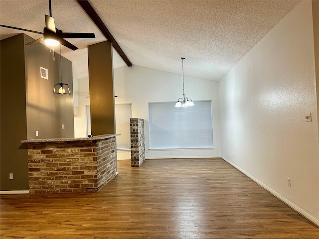 unfurnished living room featuring a textured ceiling, hardwood / wood-style floors, ceiling fan with notable chandelier, and vaulted ceiling with beams