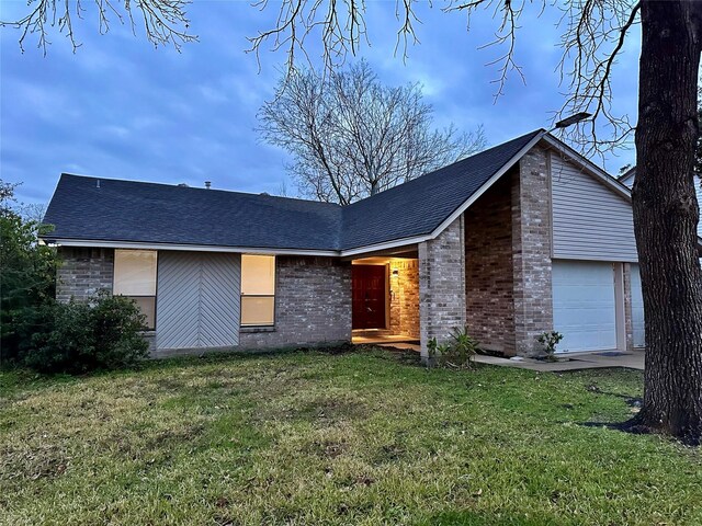 view of front of home with a front lawn and a garage