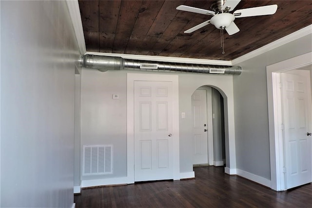 unfurnished bedroom with ceiling fan, dark wood-type flooring, ornamental molding, and wood ceiling