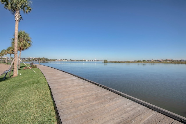 dock area featuring a water view and a yard