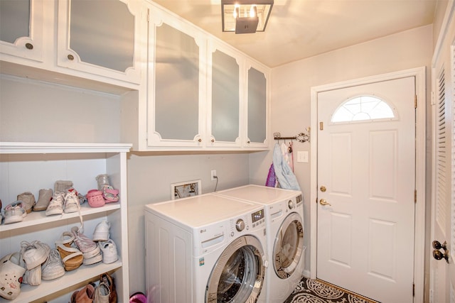 laundry room featuring cabinets and washing machine and clothes dryer