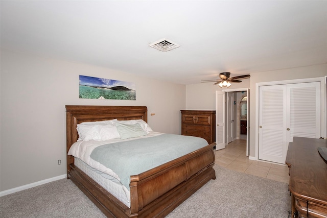 carpeted bedroom with ceiling fan and a closet