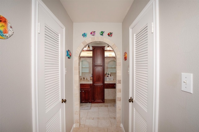 hallway featuring light tile patterned floors