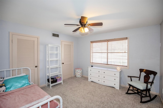 bedroom with ceiling fan and light carpet