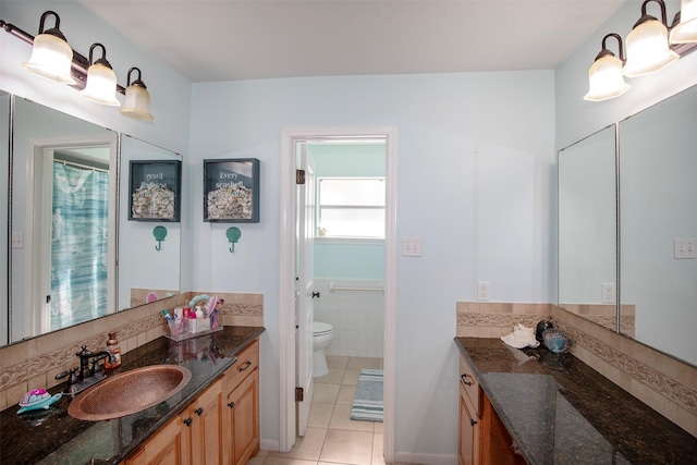 bathroom with tile patterned floors, vanity, and toilet