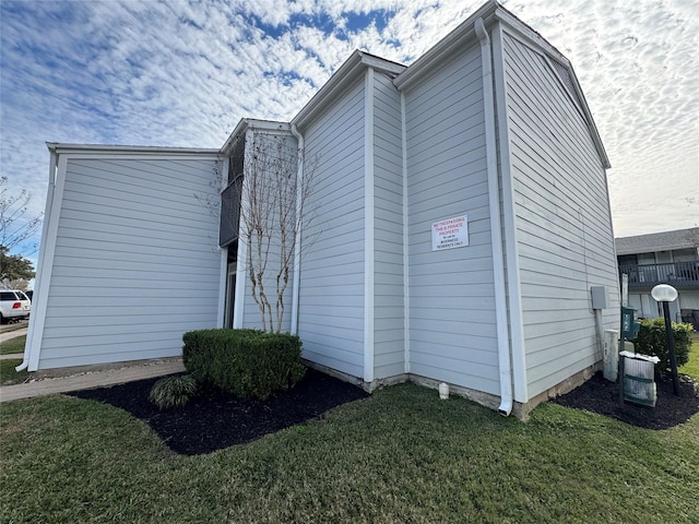 view of home's exterior featuring cooling unit and a yard