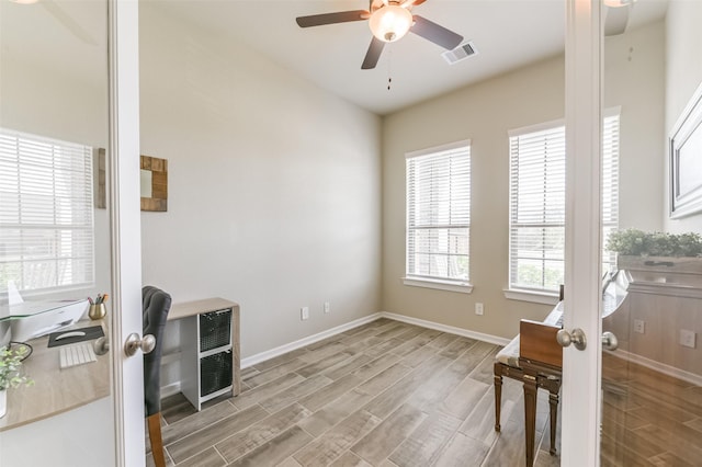 interior space with ceiling fan, light wood-type flooring, and french doors