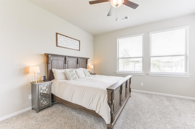 bedroom with ceiling fan and light carpet