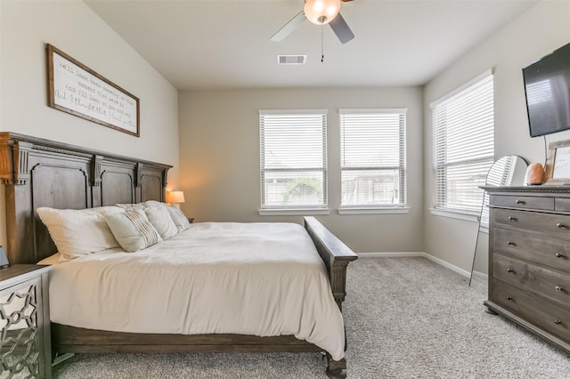 bedroom with ceiling fan and light carpet