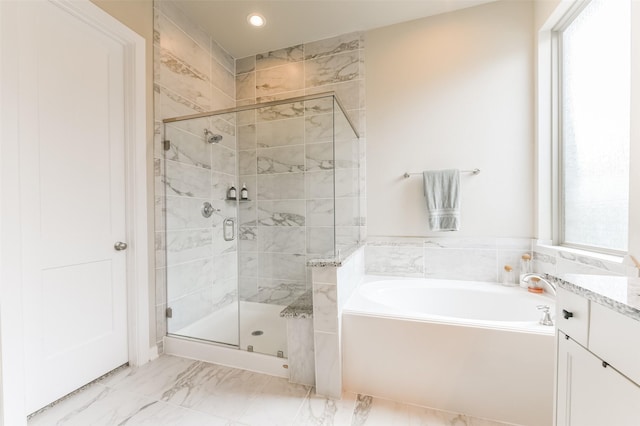 bathroom featuring vanity and plus walk in shower