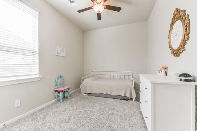 bedroom with ceiling fan and light carpet