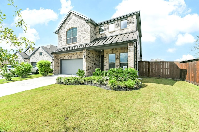 view of front of house with a garage and a front lawn