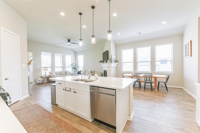 kitchen featuring white cabinets, sink, a kitchen island with sink, ceiling fan, and stainless steel dishwasher