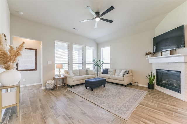 living room featuring ceiling fan and vaulted ceiling