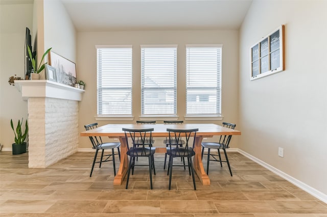 dining room with lofted ceiling and a healthy amount of sunlight