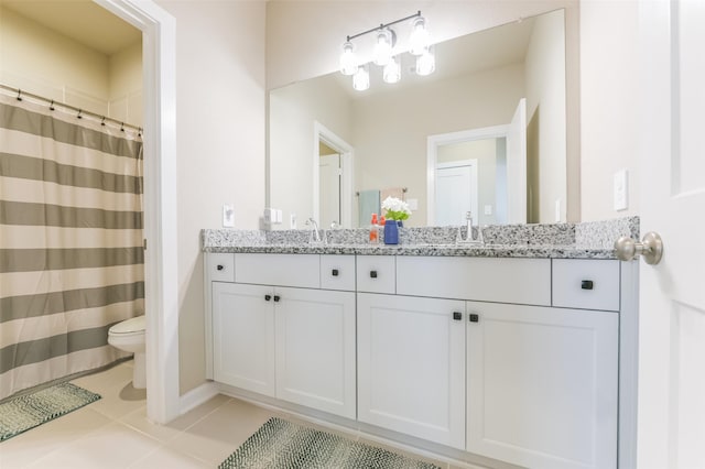 bathroom with toilet, tile patterned flooring, vanity, and curtained shower