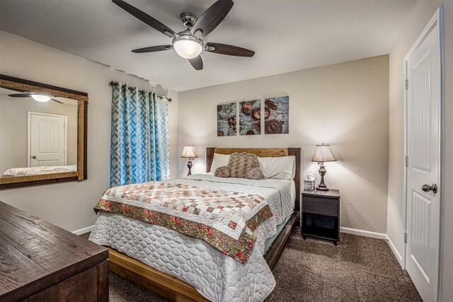 bedroom featuring ceiling fan and dark carpet