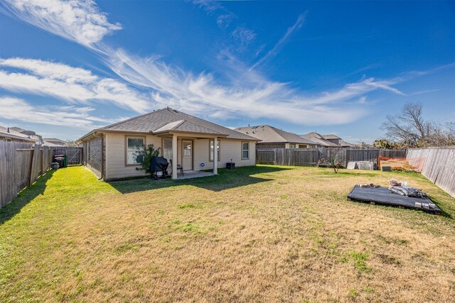 back of property featuring a lawn