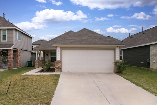 view of front of property featuring a front lawn and a garage