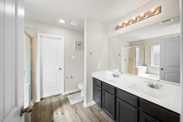 full bathroom with toilet, hardwood / wood-style floors, separate shower and tub, and vanity