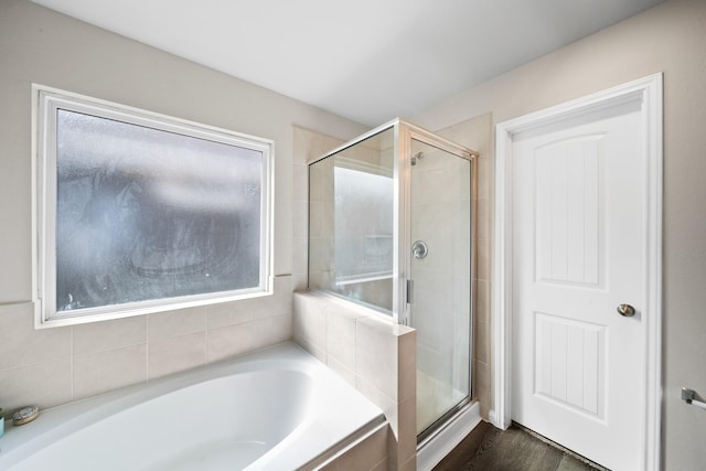 bathroom with hardwood / wood-style floors and plus walk in shower