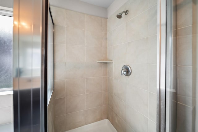 bathroom with a tile shower