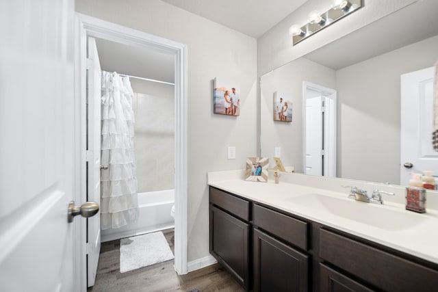 full bathroom with toilet, vanity, wood-type flooring, and shower / bath combo with shower curtain